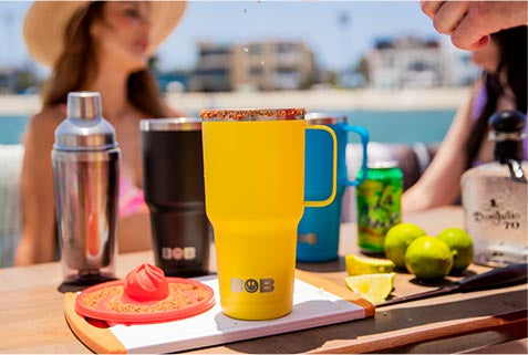 Three 30oz "Big Sipper" Tumblers on a table on a boat along with various drink making supplies.
